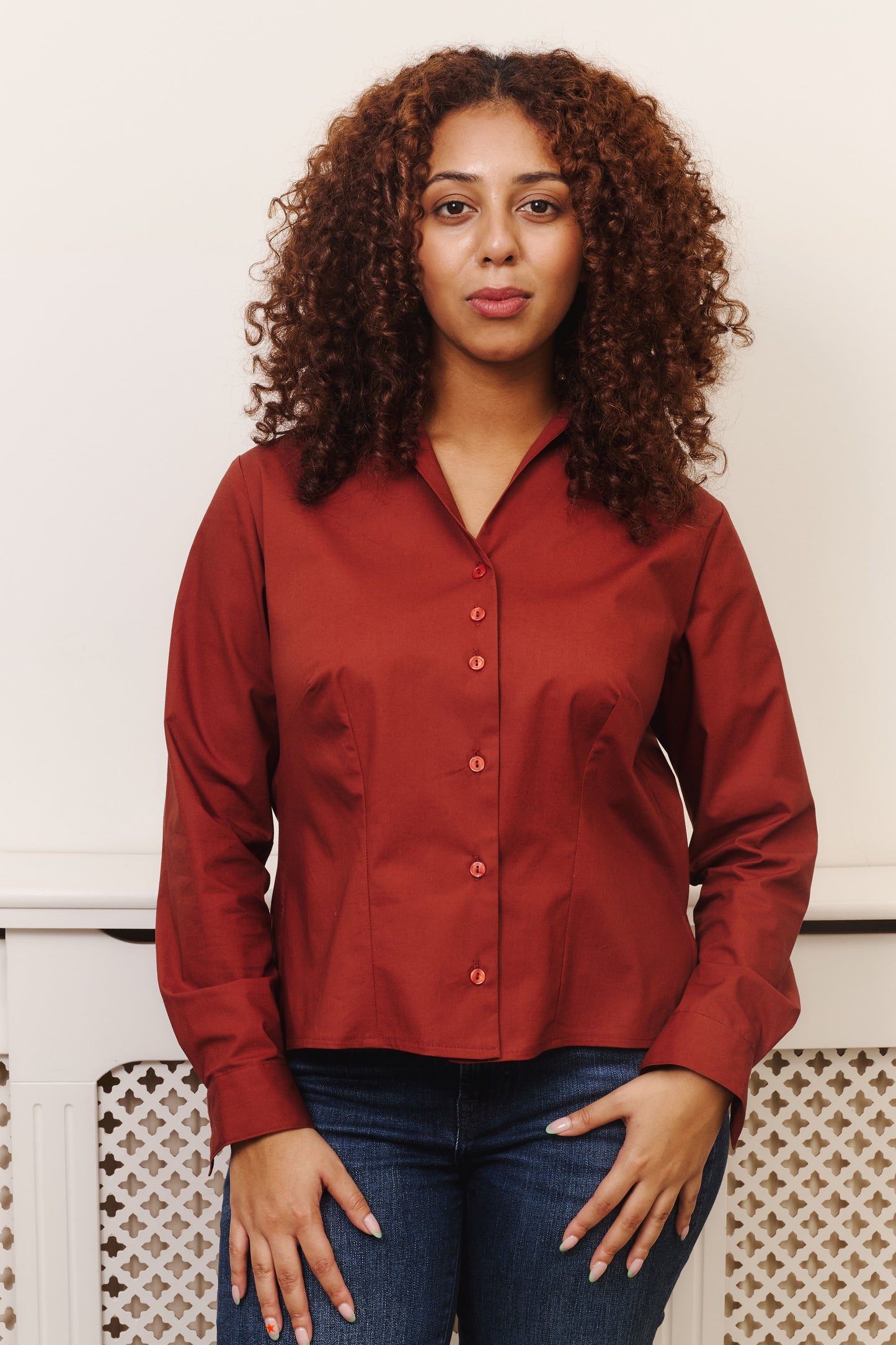 Front view fuller bust model wearing the Cinnamon Nova shirt, designed to flatter curvy figures, a smooth fit without any button gaps, tugging, or constriction around the bust. Tailored with darts to fit your bust, flattering open collar and regular cuff with a single button.