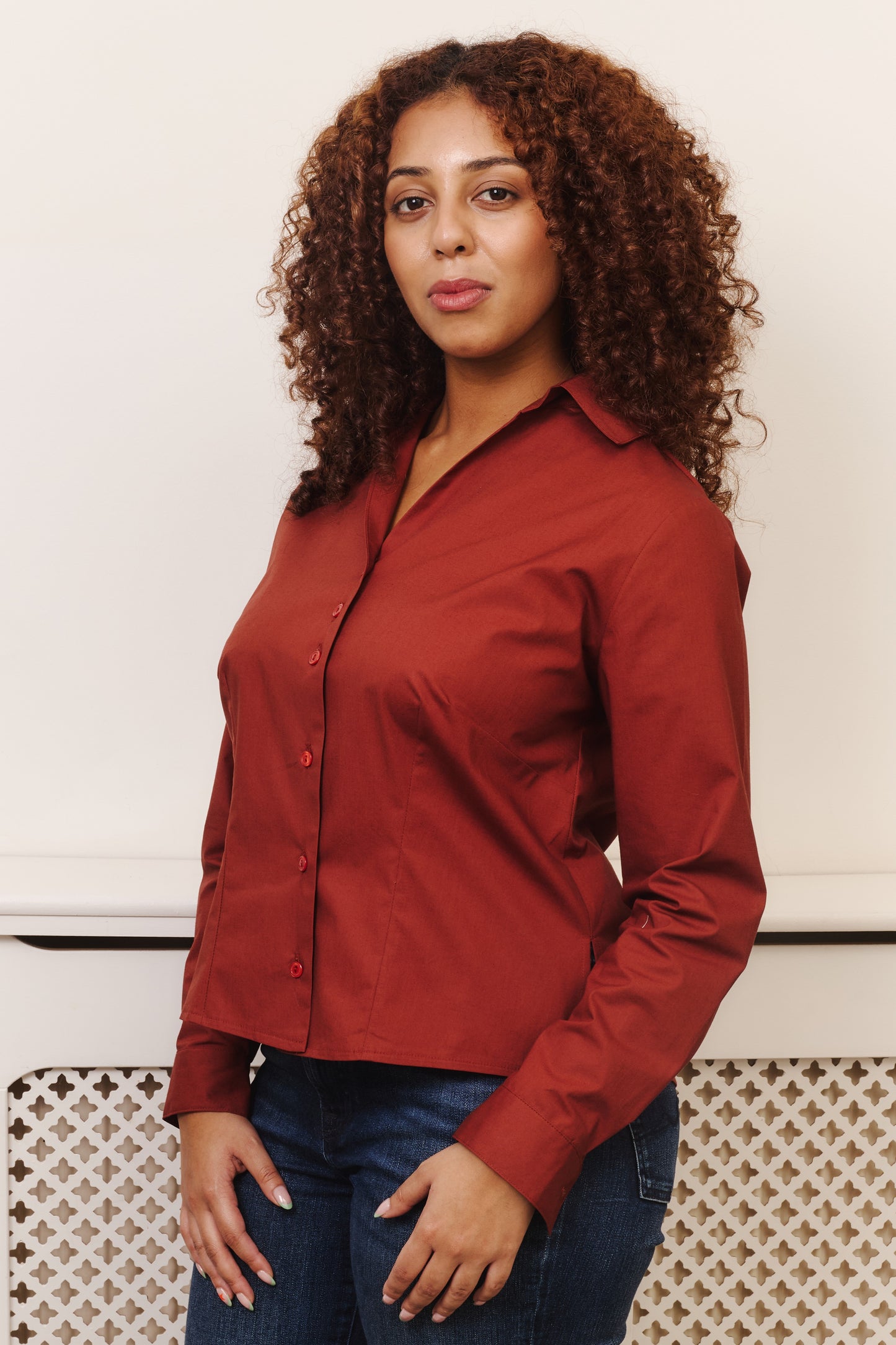 Front view fuller bust model wearing the Cinnamon Nova shirt, designed to flatter curvy figures, a smooth fit without any button gaps, tugging, or constriction around the bust. Tailored with darts to fit your bust, flattering open collar and regular cuff with a single button. 